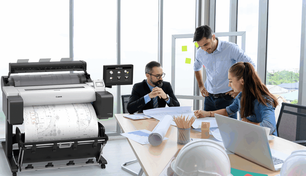Office employees collaborating around wide document printer